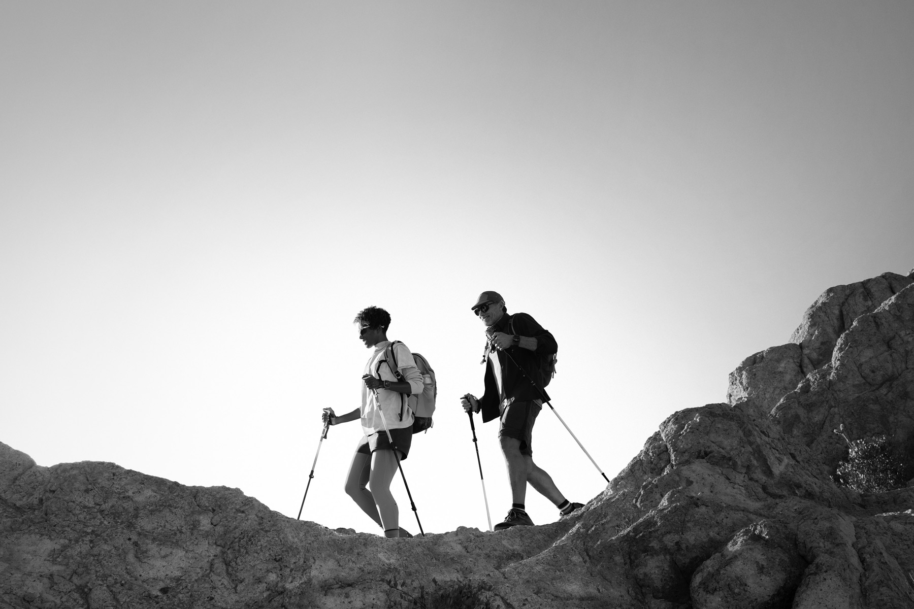 Deux personnes portant une Apple Watch Ultra 3 font une randonnée en montagne