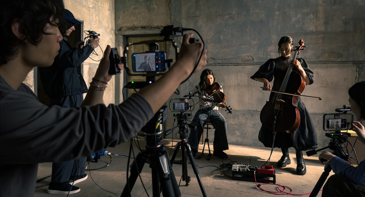 iPhone 17 Pro sits on a tripod showing the Genlock and time code support feature while recording during a film shoot